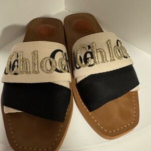 Chloe sandals size 6. Sandals are black with cream and gold lettering .